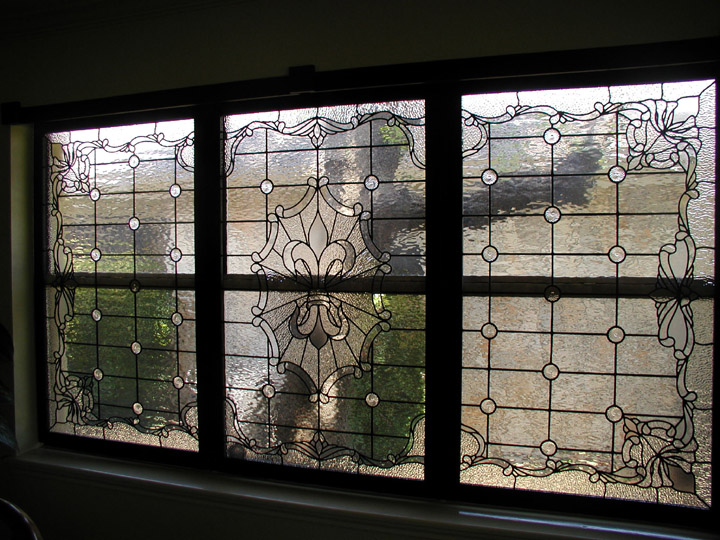 Custom leaded clear textured glass window set featuring a fluer di lis and victorian elements
