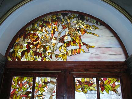 Stained glass scene in residential building lobby doors and transoms