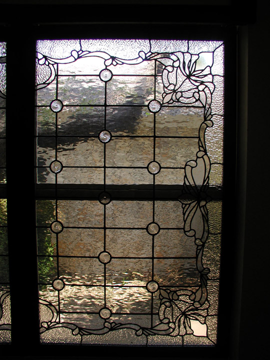 Custom leaded clear textured glass window set featuring a fluer di lis and victorian elements