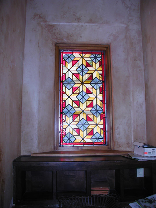 Geometric stained glass quilt window