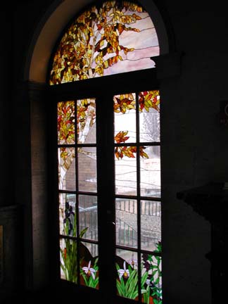 Stained glass scene in residential building lobby doors and transoms